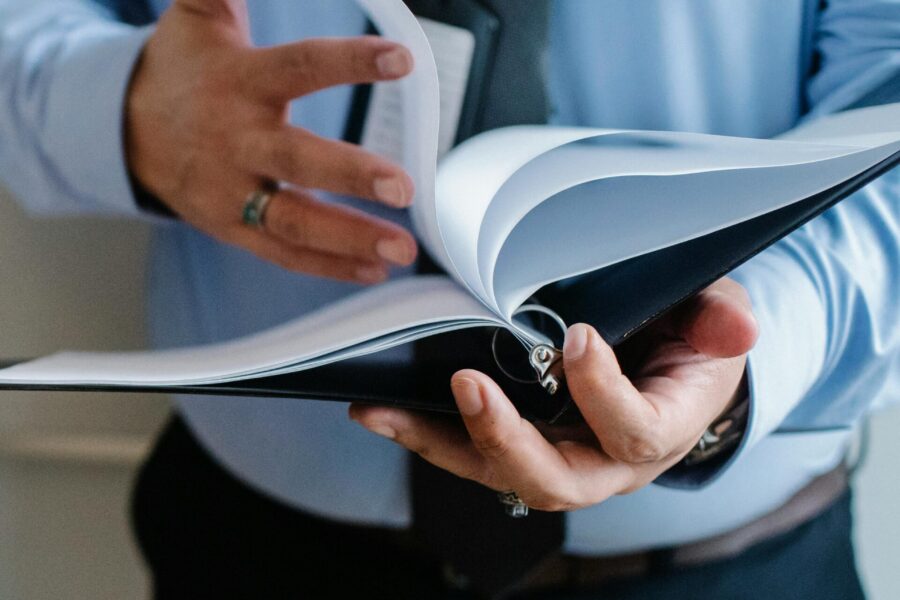 Man hold in a file that he's turning the page of